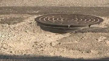 Several drivers get flat tires from popped up manhole cover on busy Midtown road