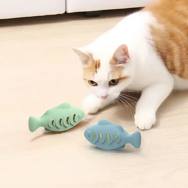cat chewing fish toys