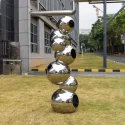 Stainless steel sphere sculpture of grass in outdoor park square